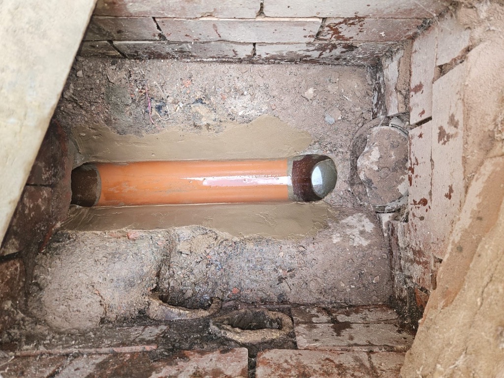 Drain restoration completed: new clay channel fitted and smooth sealed benching